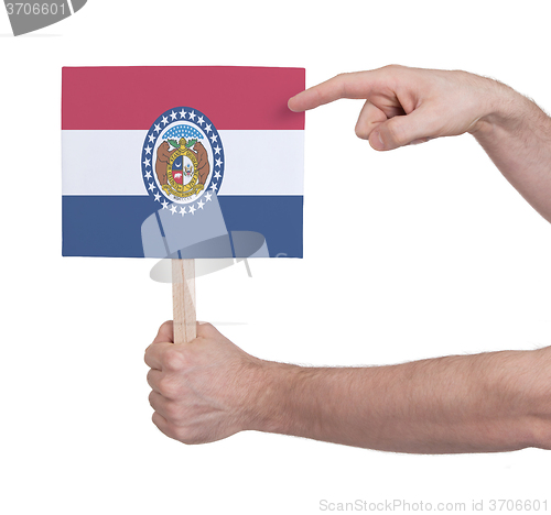 Image of Hand holding small card - Flag of Missouri