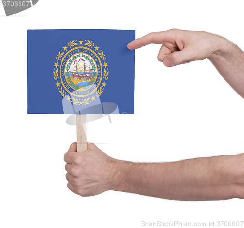 Image of Hand holding small card - Flag of New Hampshire