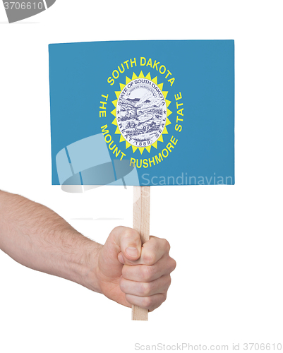 Image of Hand holding small card - Flag of South Dakota