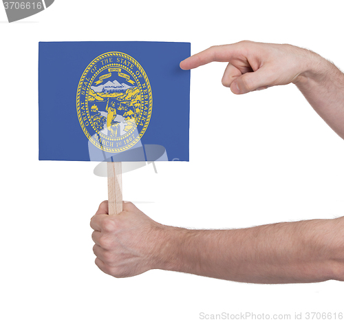 Image of Hand holding small card - Flag of Nebraska