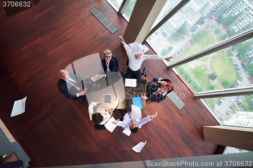 Image of top view of business people group throwing dociments in air