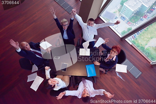 Image of top view of business people group throwing dociments in air