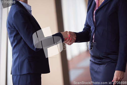 Image of business womans make deal and handshake