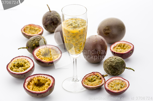 Image of Passion Fruit Flesh In A Flute Amidst Cut Fruits