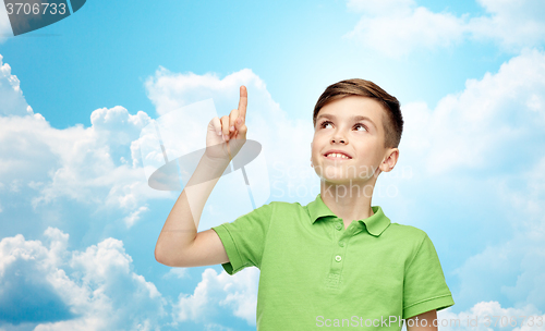 Image of happy boy in green polo t-shirt pointing finger up