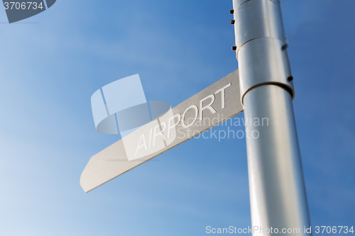 Image of close up of airport signpost over blue sky