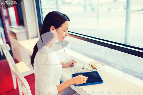 Image of smiling woman with tablet pc and coffee at cafe