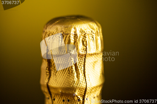 Image of close up of champagne bottle cork wrapped in foil