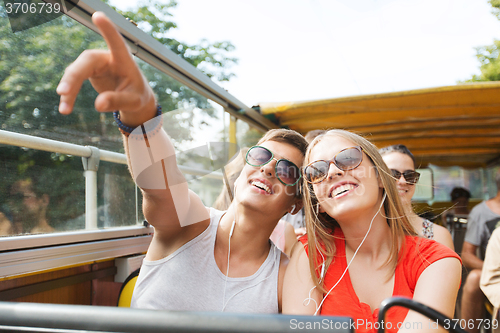 Image of happy teenage couple traveling by tour bus