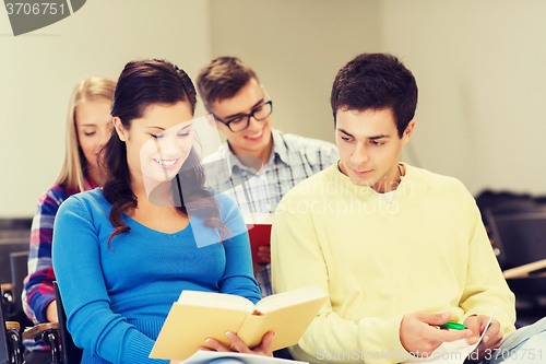 Image of group of smiling students with notebooks