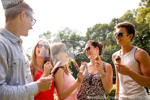 Image of group of smiling friends with ice cream outdoors