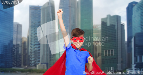 Image of boy in red super hero cape and mask showing fists