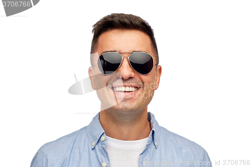 Image of face of smiling man in shirt and sunglasses