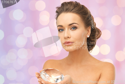 Image of woman showing big diamond over pink lights