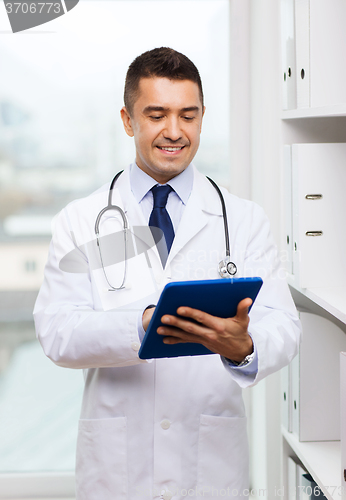Image of smiling male doctor in white coat with tablet pc