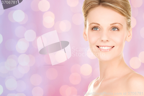 Image of lovely woman face over pink lights background