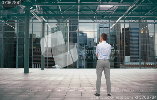 Image of businessman from back over city construction