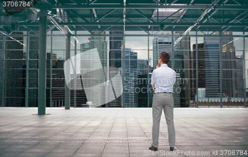 Image of businessman from back over city construction