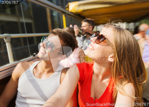 Image of happy teenage couple traveling by tour bus