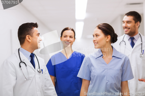Image of happy group of medics or doctors at hospital