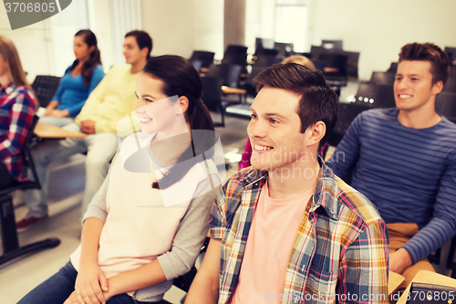 Image of group of smiling students in lecture hall