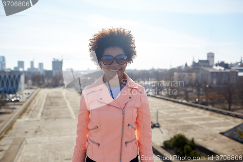 Image of happy african american woman in shades on street