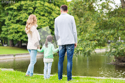 Image of family walking in summer park