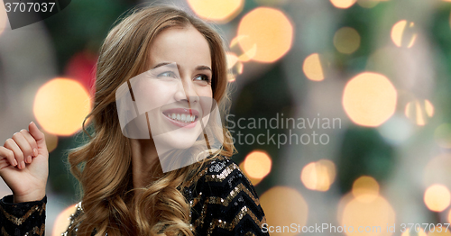 Image of happy young woman dancing at night club disco