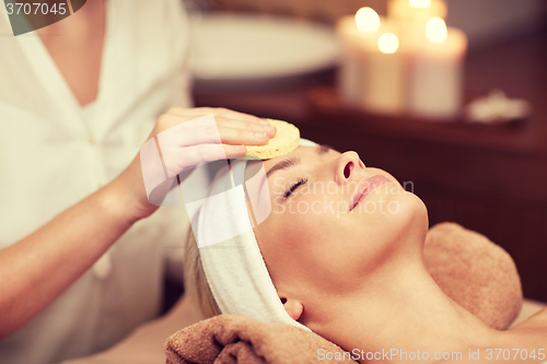 Image of close up of woman having face cleaning in spa