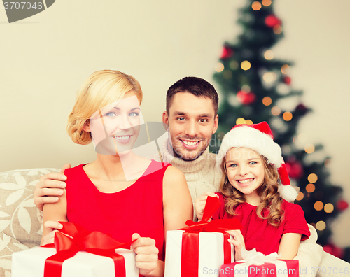 Image of smiling family holding many gift boxes