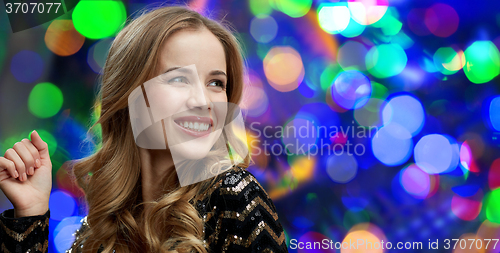 Image of happy young woman dancing at night club disco