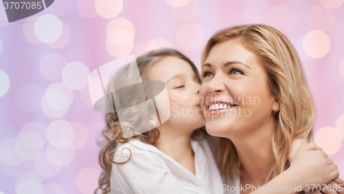 Image of happy little girl hugging and kissing her mother