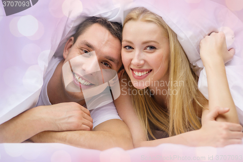 Image of happy couple sleeping in bed