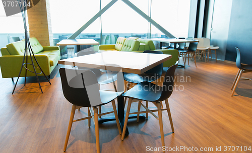 Image of restaurant interior with table and chairs