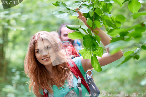 Image of group of smiling friends with backpacks hiking