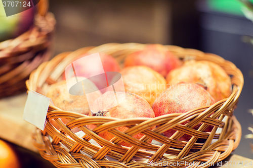 Image of ripe pomegranates in basket at food market