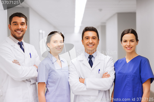 Image of happy group of medics or doctors at hospital