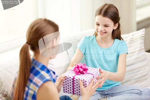 Image of happy little girls with birthday present at home