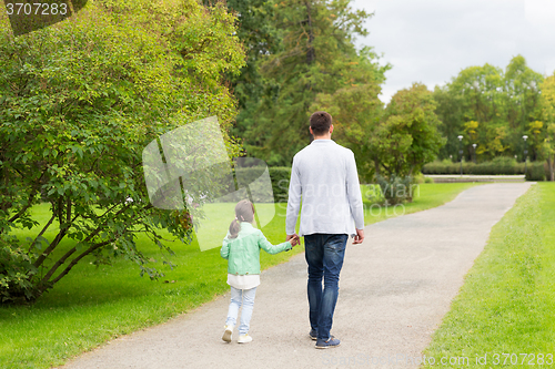 Image of happy family walking in summer park