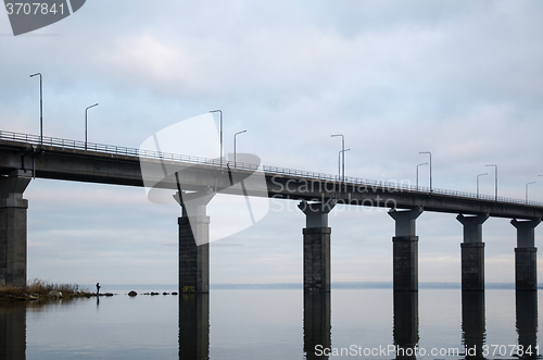 Image of Angling man by the bridge