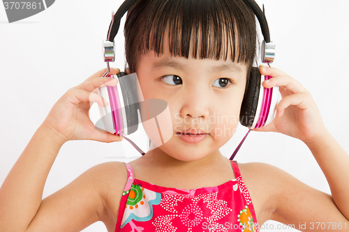 Image of Chinese little girl on headphones