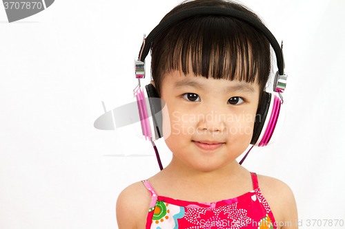 Image of Chinese little girl on headphones