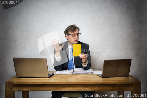 Image of Business man with yellow card