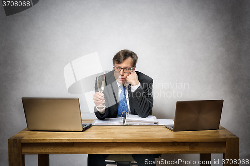 Image of Lonely business man with champagne glass