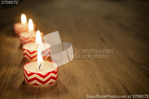 Image of Romantic candles on wooden table