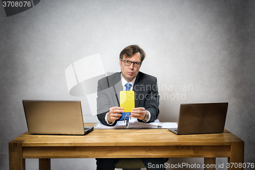 Image of Business man with yellow card