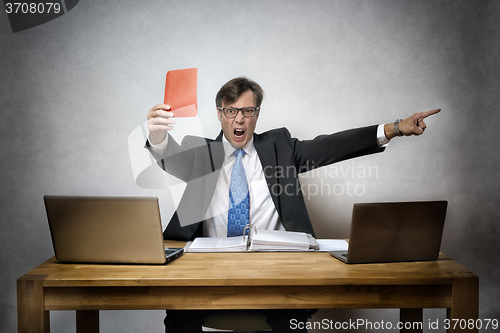 Image of Angry business man with red card