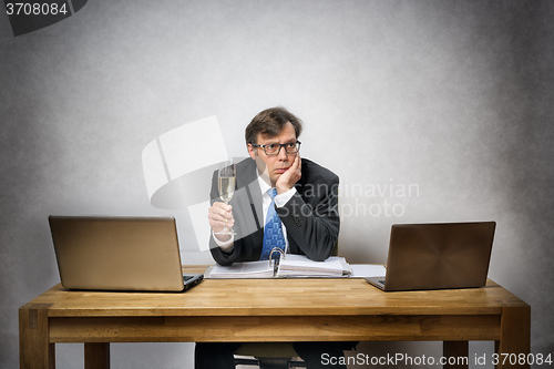 Image of Lonely business man with champagne glass
