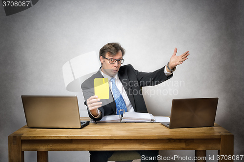 Image of Business man with yellow card