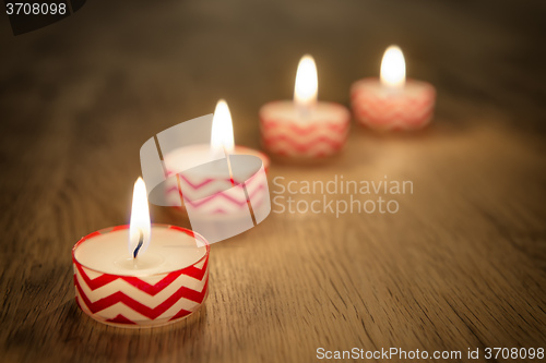 Image of Romantic candles on wooden table